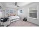 Bright bedroom with neutral walls, a ceiling fan, and a cozy armchair at 4073 S Liverpool St, Aurora, CO 80013
