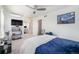 Well-lit bedroom with bright walls, a ceiling fan, carpet and a view to an adjacent study at 4073 S Liverpool St, Aurora, CO 80013
