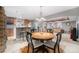 Open game room featuring dining table and chairs, kitchen area, and open area with couches at 4073 S Liverpool St, Aurora, CO 80013