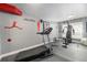 A modern home gym equipped with a treadmill, weight machine, and motivational wall art at 4073 S Liverpool St, Aurora, CO 80013