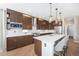 Modern kitchen with dark wood cabinets, a center island, and stainless steel appliances at 4073 S Liverpool St, Aurora, CO 80013