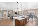 Open-concept kitchen with stainless steel appliances, a center island, and modern lighting at 4073 S Liverpool St, Aurora, CO 80013
