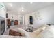 Bright living room with a wet bar, access to additional rooms, and a cozy seating area at 4073 S Liverpool St, Aurora, CO 80013