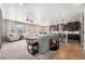 Spacious open-concept living room with a large sofa, hardwood floors, and kitchen access at 4073 S Liverpool St, Aurora, CO 80013