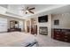 Comfortable main bedroom with a fireplace, mounted TV, and neutral color palette at 4073 S Liverpool St, Aurora, CO 80013