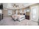 Spacious main bedroom boasting a fireplace, a ceiling fan, and access to a private outdoor space at 4073 S Liverpool St, Aurora, CO 80013