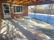 Spacious covered back patio features concrete flooring and access to backyard at 1120 Tucson St, Aurora, CO 80011