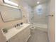 Updated bathroom with white vanity and bathtub at 1120 Tucson St, Aurora, CO 80011