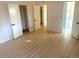 A spacious bedroom features modern floors and easy access to the closet and bathroom at 1120 Tucson St, Aurora, CO 80011