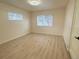 A cozy bedroom featuring natural light from two large windows at 1120 Tucson St, Aurora, CO 80011