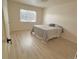 Bright bedroom with hardwood floors and a queen-size bed at 1120 Tucson St, Aurora, CO 80011