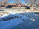 Front yard with driveway and partial snow coverage at 1120 Tucson St, Aurora, CO 80011