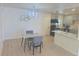 Modern kitchen with new grey cabinets, new island, and a chandelier at 1120 Tucson St, Aurora, CO 80011