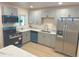 Newly renovated kitchen with gray cabinets and quartz countertops at 1120 Tucson St, Aurora, CO 80011