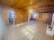 Bright living room with wood paneling, fireplace, and hardwood floors at 1120 Tucson St, Aurora, CO 80011