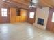 Living room with wood walls, white brick fireplace, beam ceilings, and wooden built-ins at 1120 Tucson St, Aurora, CO 80011