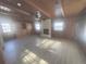 Living room with wood walls, white brick fireplace, beam ceilings, and wooden built-ins at 1120 Tucson St, Aurora, CO 80011