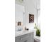 Bright bathroom with gray vanity, white subway tile, and a large mirror at 3422 S Grant St, Englewood, CO 80113