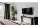 Bedroom with large TV and a modern console table at 3422 S Grant St, Englewood, CO 80113