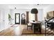 Bright dining area with wood table, unique lighting, and hardwood floors at 3422 S Grant St, Englewood, CO 80113