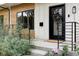 Stylish front entrance with black door, wreath, and metal railing at 3422 S Grant St, Englewood, CO 80113