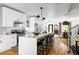 Modern kitchen with white cabinets, island, and hardwood floors at 3422 S Grant St, Englewood, CO 80113