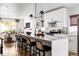 Modern kitchen with white cabinets, large island, and stainless steel appliances at 3422 S Grant St, Englewood, CO 80113