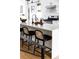 Kitchen island with seating, quartz countertop and black barstools at 3422 S Grant St, Englewood, CO 80113