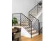 Modern staircase with sleek metal railing and hardwood steps at 3422 S Grant St, Englewood, CO 80113