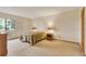 Neutral bedroom with carpet, a double bed, side tables with lamps and access to a window at 13952 E Marina Dr # 102, Aurora, CO 80014