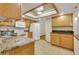 Updated kitchen features granite countertops, white appliances, tile floors, and updated cabinets at 13952 E Marina Dr # 102, Aurora, CO 80014