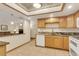 Updated kitchen showcasing granite countertops, white appliances, tile floors, and updated cabinets at 13952 E Marina Dr # 102, Aurora, CO 80014