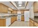 Updated kitchen featuring granite countertops, white appliances, tile floors, and updated cabinets at 13952 E Marina Dr # 102, Aurora, CO 80014
