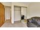 Living room view with closet, mirror closet doors and a comfortable sofa at 13952 E Marina Dr # 102, Aurora, CO 80014