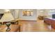 Open-concept living area showcasing wood floors, a dining table set and a view into the kitchen at 13952 E Marina Dr # 102, Aurora, CO 80014