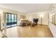 Bright living room with wood floors, comfortable seating, a flatscreen TV, and sliding door access to the outdoors at 13952 E Marina Dr # 102, Aurora, CO 80014