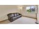Relaxing living room featuring a comfortable sofa and a sunny window at 13952 E Marina Dr # 102, Aurora, CO 80014