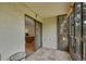 Enclosed patio with tile flooring and view of office and mature trees for added outdoor relaxation at 13952 E Marina Dr # 102, Aurora, CO 80014