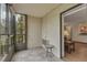 Enclosed patio with tile flooring and view of main living area and mature trees for added outdoor relaxation at 13952 E Marina Dr # 102, Aurora, CO 80014
