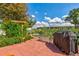 Outdoor patio area featuring a grill, bench, arbor, and landscaped garden at 13952 E Marina Dr # 102, Aurora, CO 80014