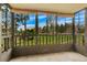 Relaxing sunroom with tile flooring, black metal guardrails and a beautiful view of the community park at 13952 E Marina Dr # 102, Aurora, CO 80014
