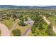 Aerial view showcases the property with multiple structures nestled in a serene landscape at 2357 Oak Ridge Rd, Sedalia, CO 80135