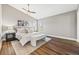 Bright bedroom featuring wood floors, a ceiling fan, and abundant natural light at 2357 Oak Ridge Rd, Sedalia, CO 80135