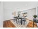 Sunlit dining room boasts a table set for four, decorative wall art, and scenic views from a large window at 2357 Oak Ridge Rd, Sedalia, CO 80135