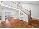 Spacious foyer features hardwood floors, a staircase with iron railing, and views into the dining area at 2357 Oak Ridge Rd, Sedalia, CO 80135