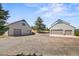 Exterior view shows two garages on the property with ample parking space at 2357 Oak Ridge Rd, Sedalia, CO 80135