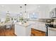 Bright kitchen with a central island, farm sink, and mountain views in an open layout at 2357 Oak Ridge Rd, Sedalia, CO 80135