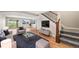 Inviting living room with an open floor plan, staircase, and seamless access to the outdoor deck at 2357 Oak Ridge Rd, Sedalia, CO 80135