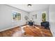 Bright home office space featuring hardwood floors, a hide rug, desk, and natural light from two windows at 2357 Oak Ridge Rd, Sedalia, CO 80135