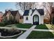 Charming home with a well-manicured lawn, arched entryway, and a neatly landscaped front yard at 2085 Krameria St, Denver, CO 80207
